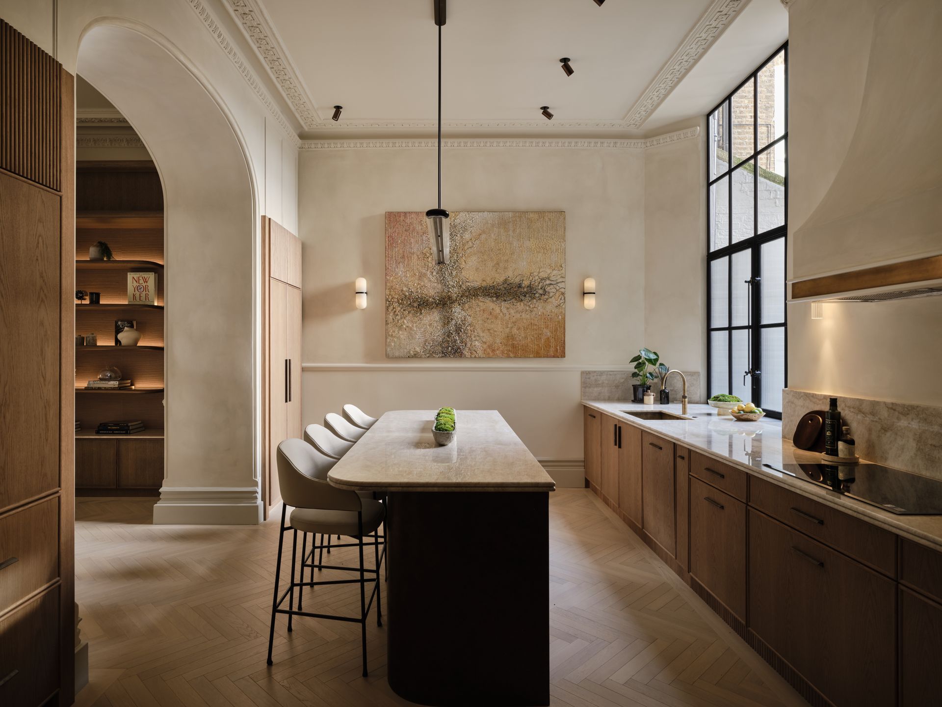 Bedroom with bed, patterned wallpaper, chandelier, and tan curtains.