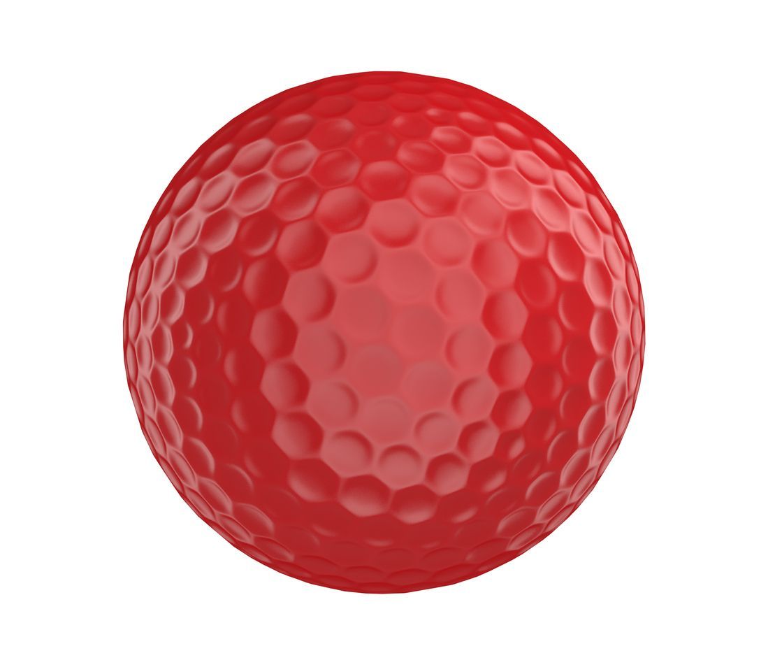 Red golf ball with dimples, isolated on white background.
