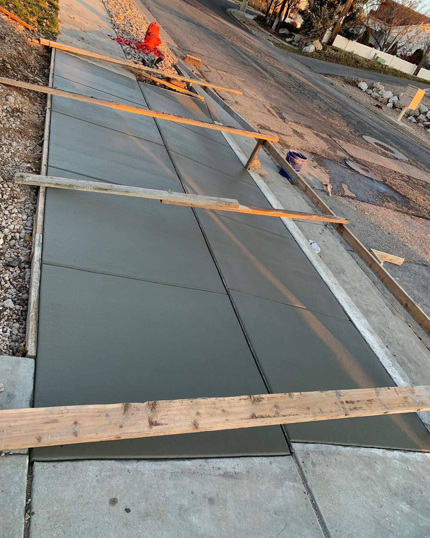 A concrete sidewalk is being built next to a road.