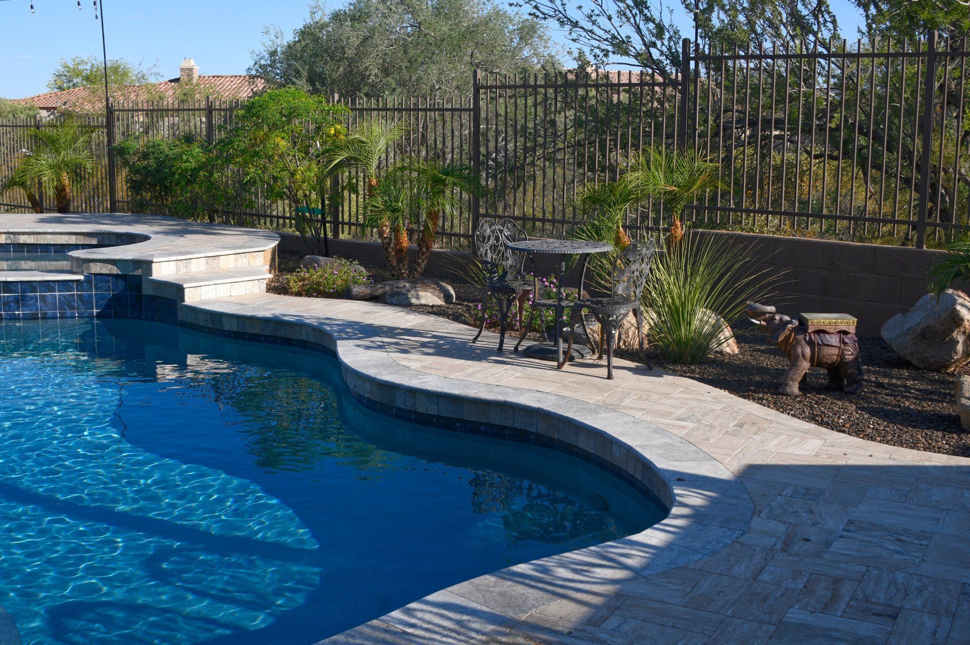 A large swimming pool with a fence surrounding it