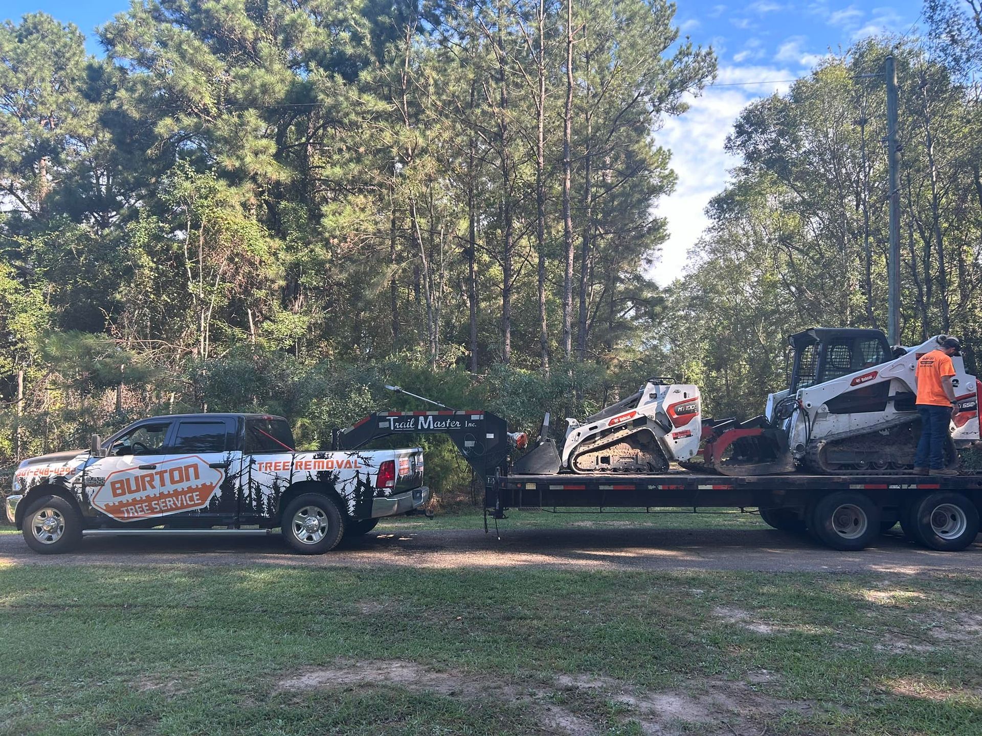 A truck is towing a bulldozer on a flatbed trailer.
