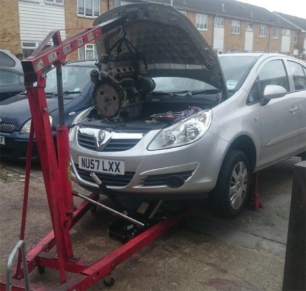 Picture of a Vauxhall Corsa with its bonnet up while it is being fixed