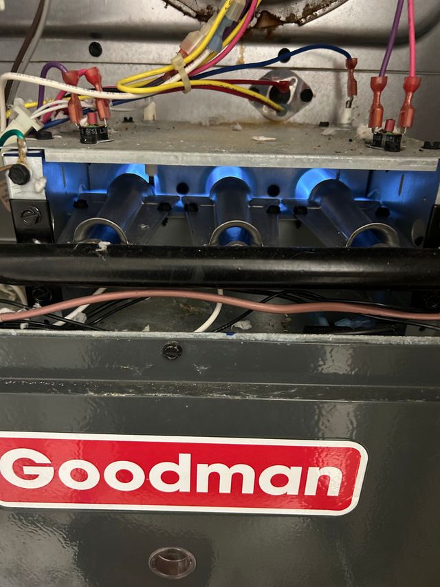 repairing a goodman gas furnace and checking the burners for proper combustion 