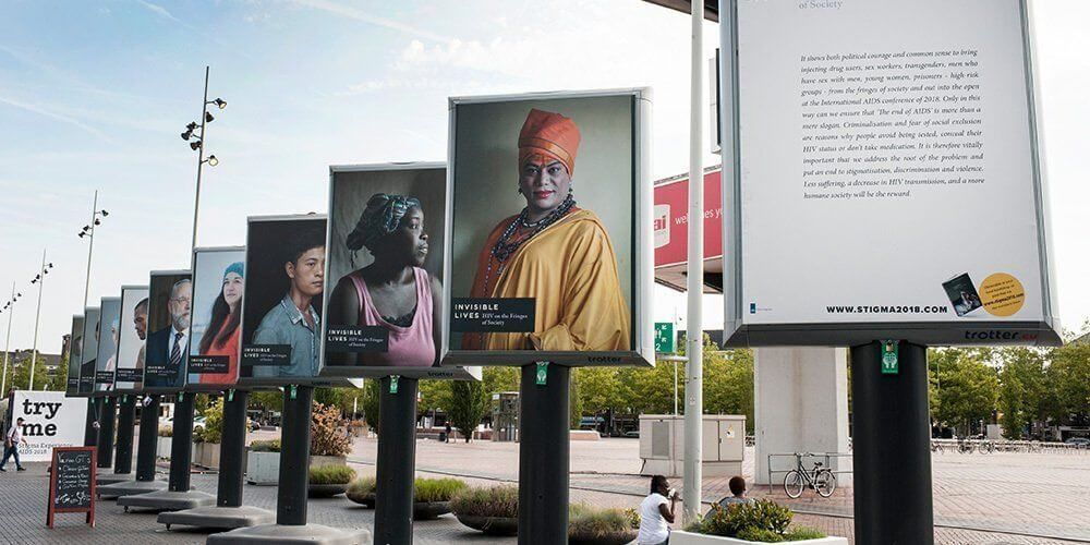 a row of billboards with one that says invisible lives