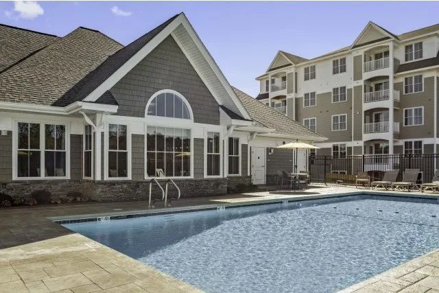 The Residences At Great Pond clubhouse exterior view and outdoor pool.
