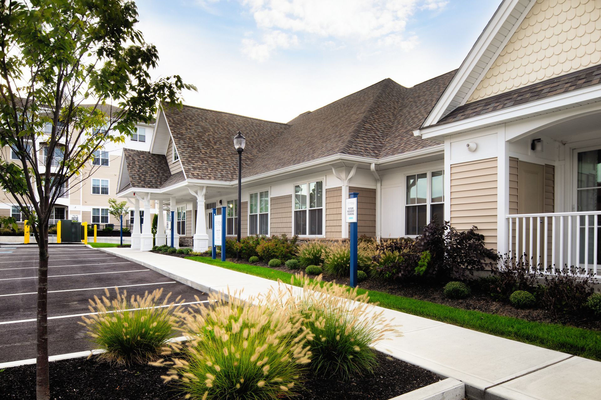 Leasing office building exterior view with outdoor parking at The Residences At Great Pond.