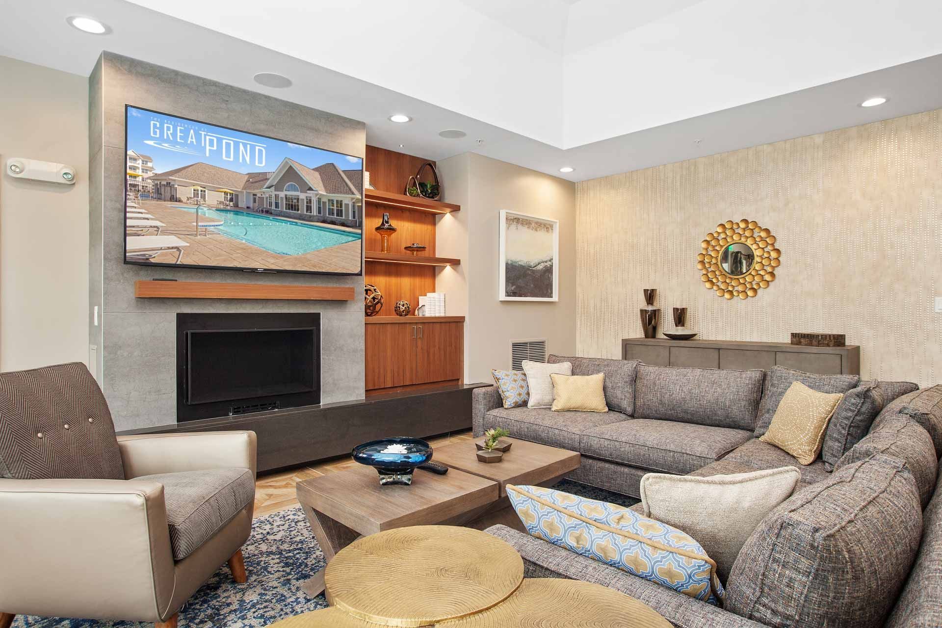 The Residences At Great Pond clubhouse with sofa and TV.