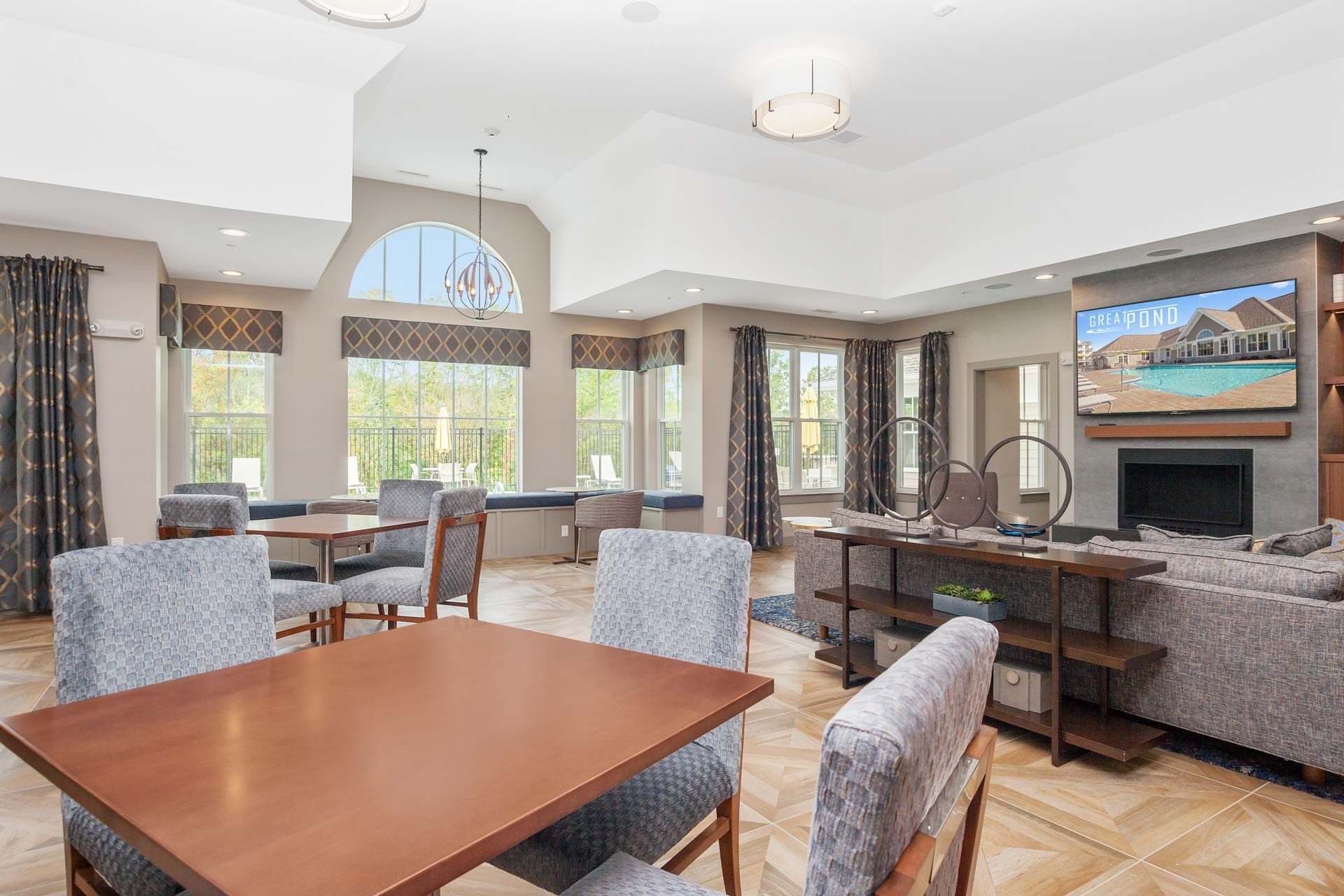 The Residences At Great Pond clubhouse with oversized windows and seating area.