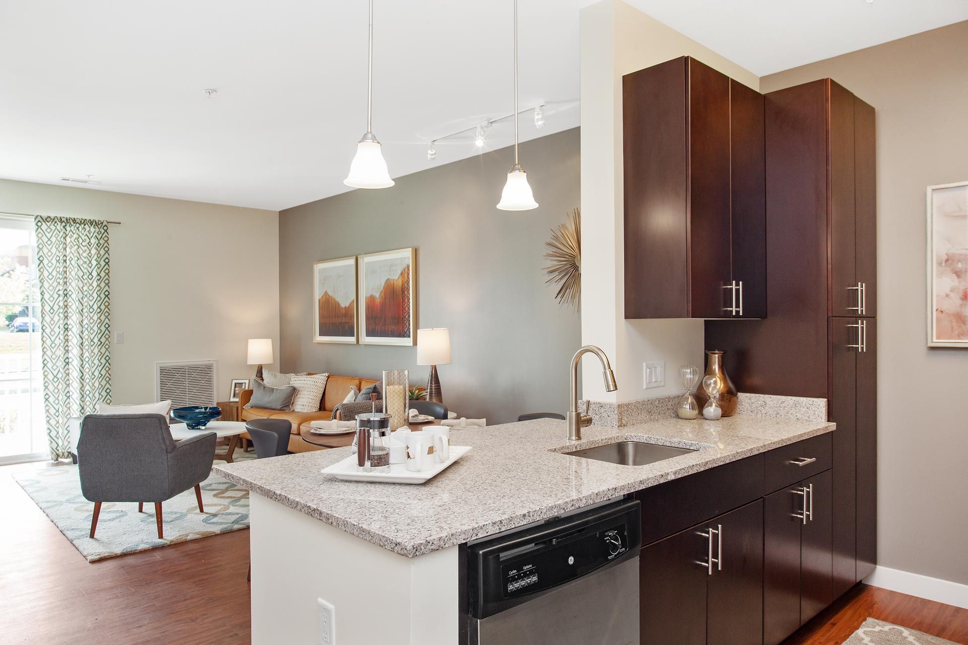 The Residences At Great Pond apartment kitchen oversees living room.