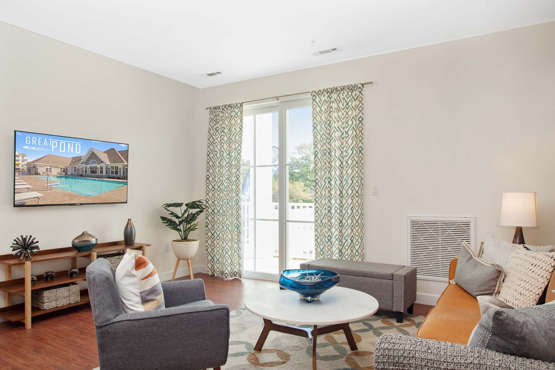 The Residences At Great Pond spacious living room with balcony.