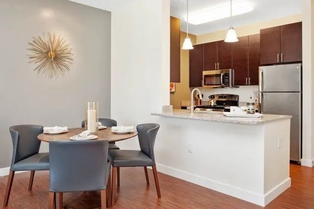 The Residences At Great Pond apartment kitchen and dining room.