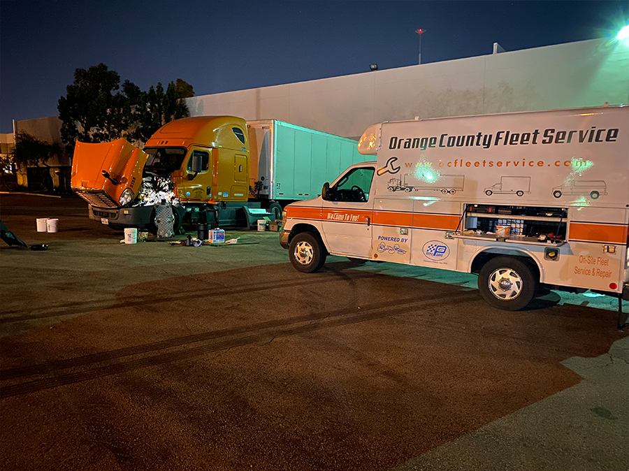 Several trucks are parked in a parking lot and one of them is from seaway county fleet service