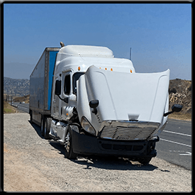 A semi truck with its hood open is sitting on the side of the road.