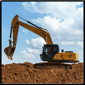 A yellow excavator is sitting on top of a pile of dirt