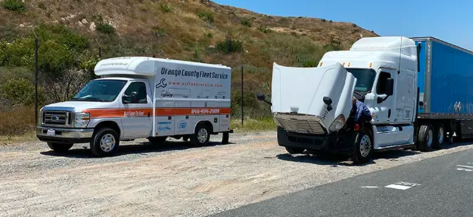 Two trucks are parked next to each other on the side of the road.