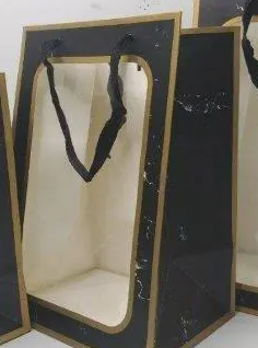 Window bag with strings pulled to form a