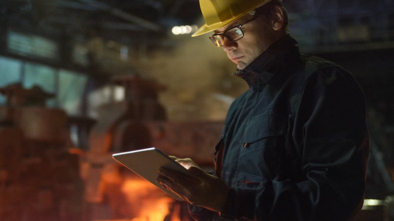 Contractor Checking his Tablet — Manchester, MO — Adams Burke & Associates LLC