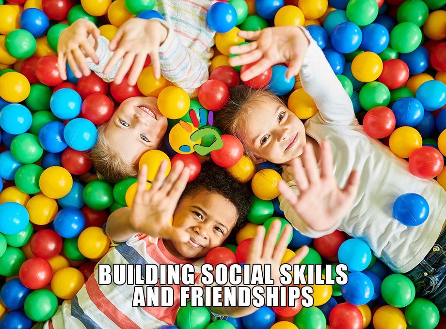 Three children are laying in a ball pit.