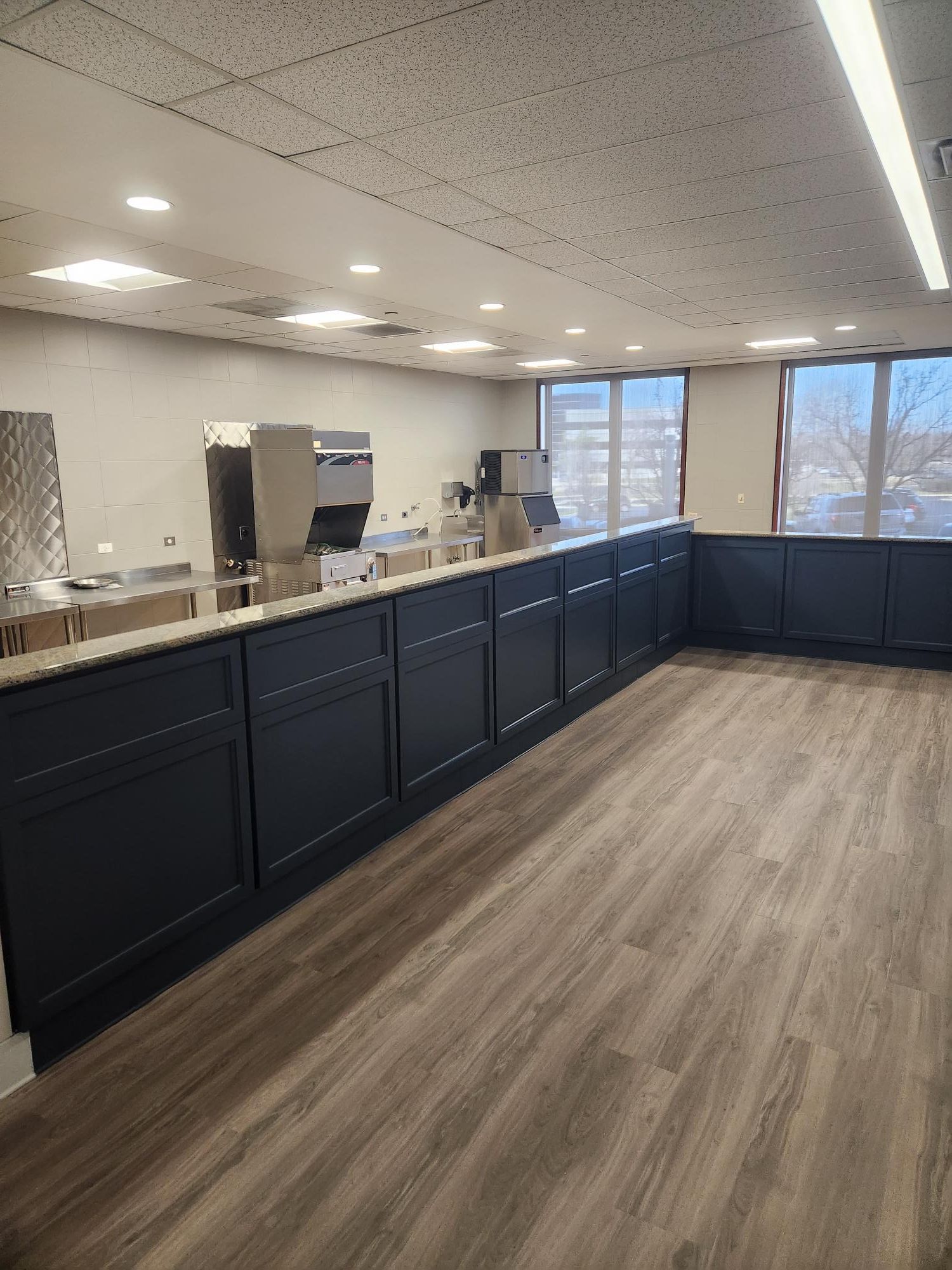 A large room with a long counter and a lot of windows.