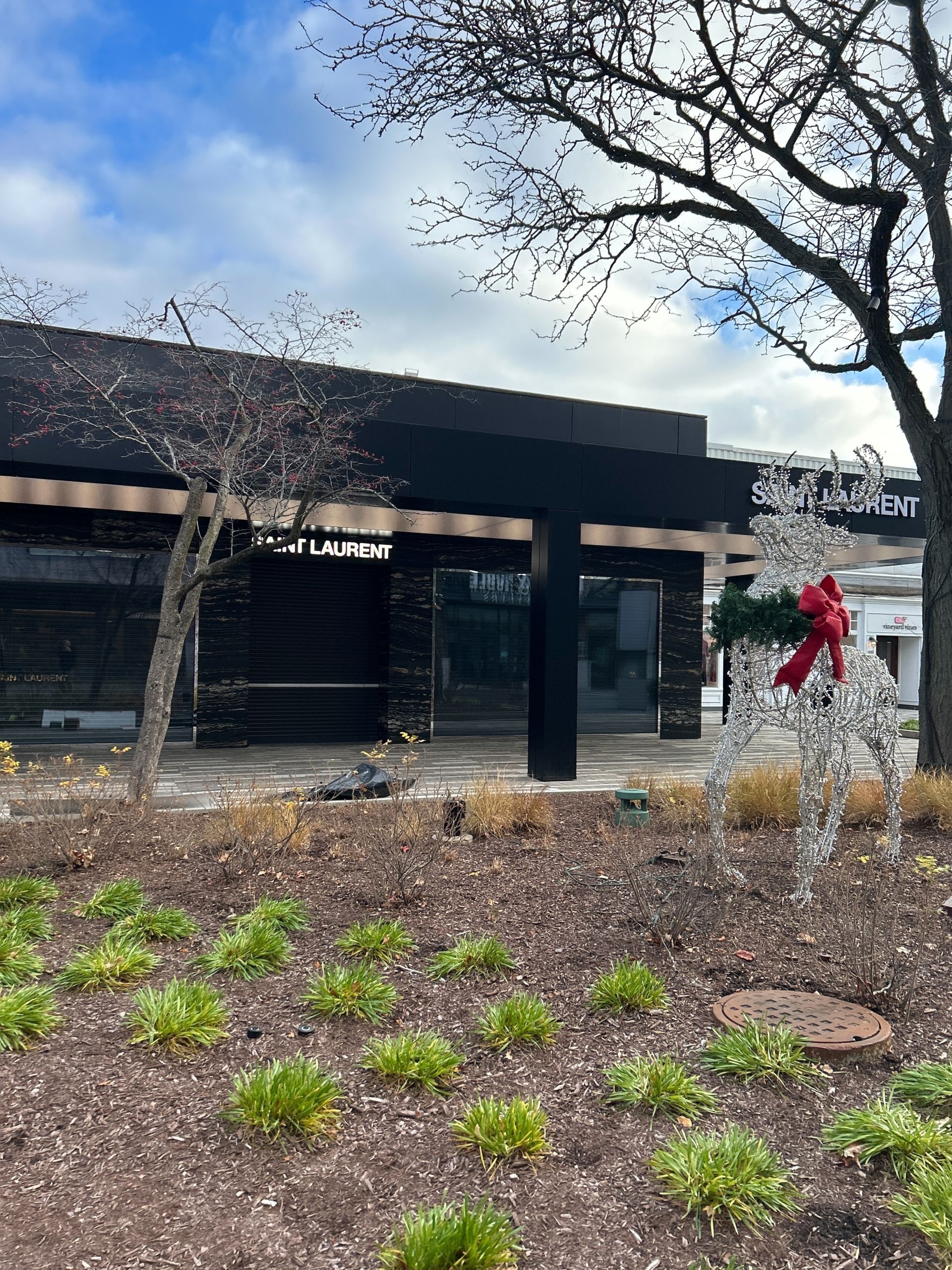 A large building with a christmas decoration in front of it.