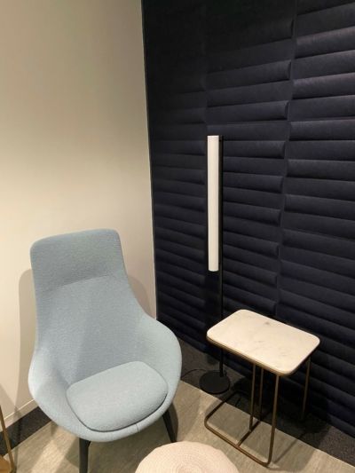 A chair and a table in a room with a blue wall