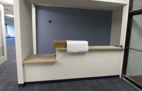 An empty reception desk with a box on top of it