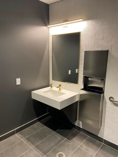 A bathroom with two sinks and a mirror