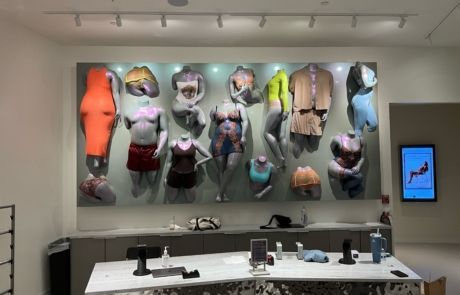 A room with a lot of mannequins on the wall