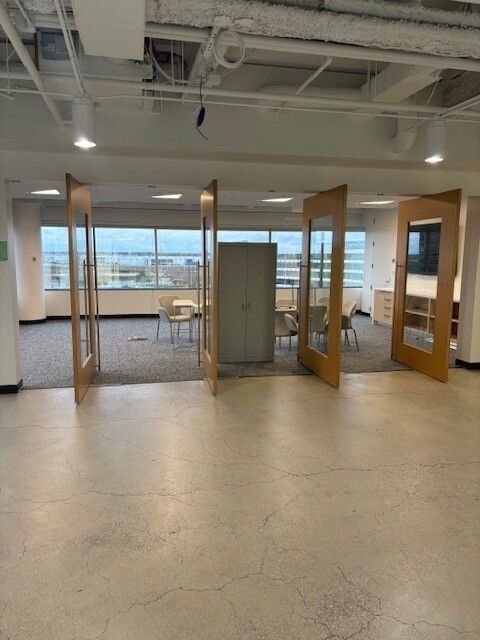 A large room with a lot of windows and doors