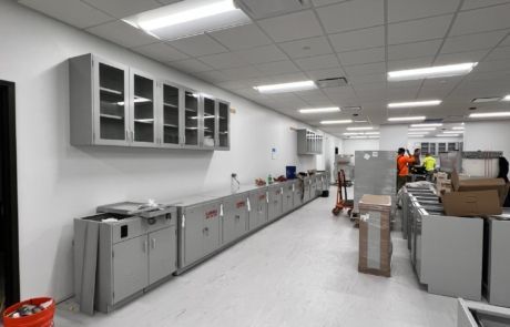A large room with a lot of cabinets and boxes on the floor.
