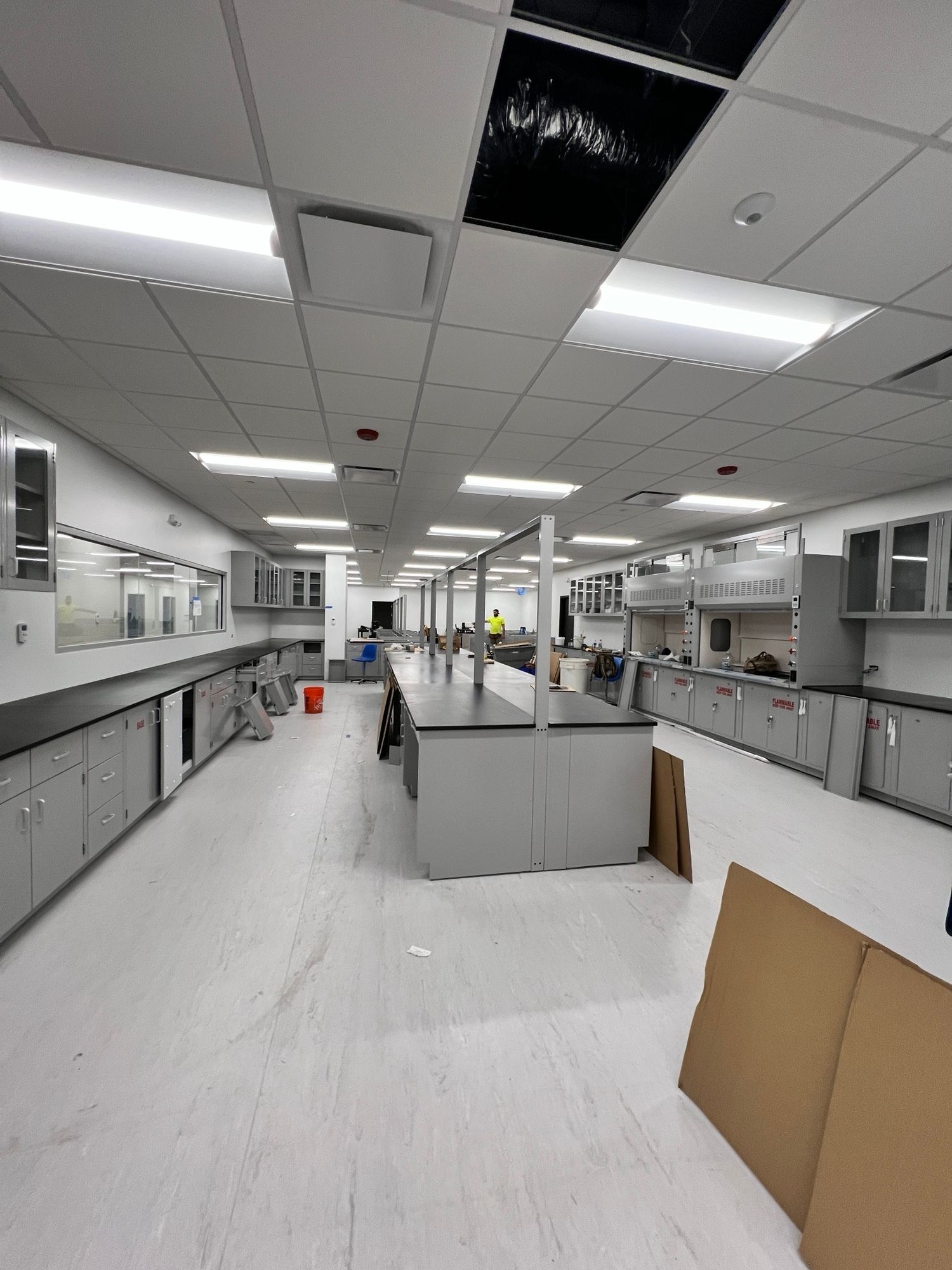 A large room with a lot of cabinets and tables in it.