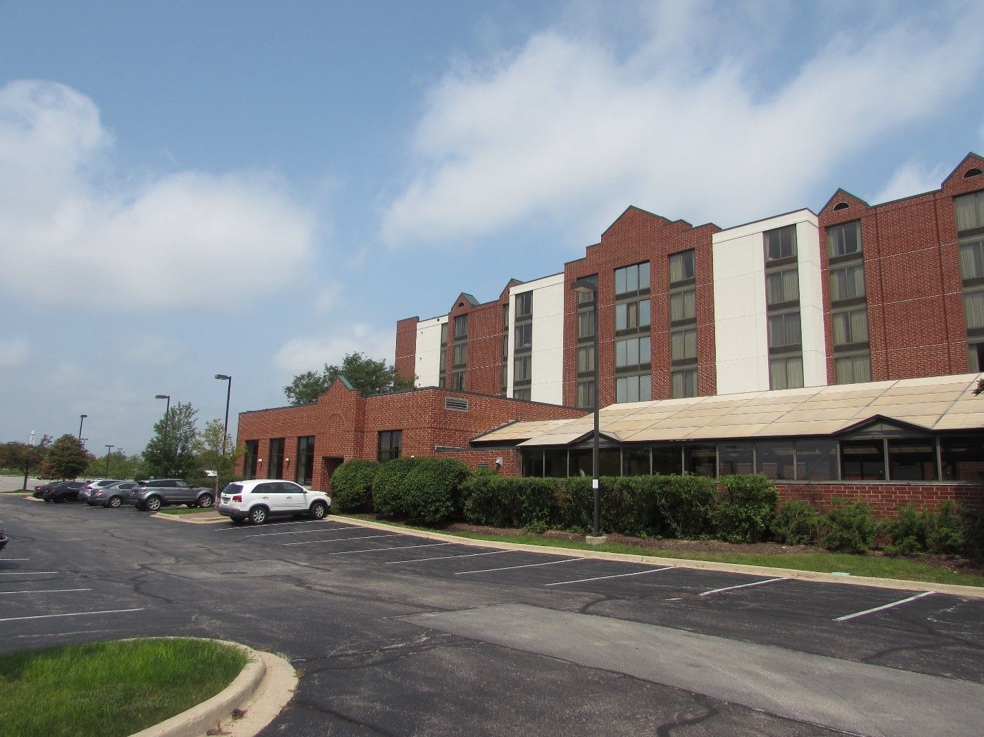 A large brick building with cars parked in front of it