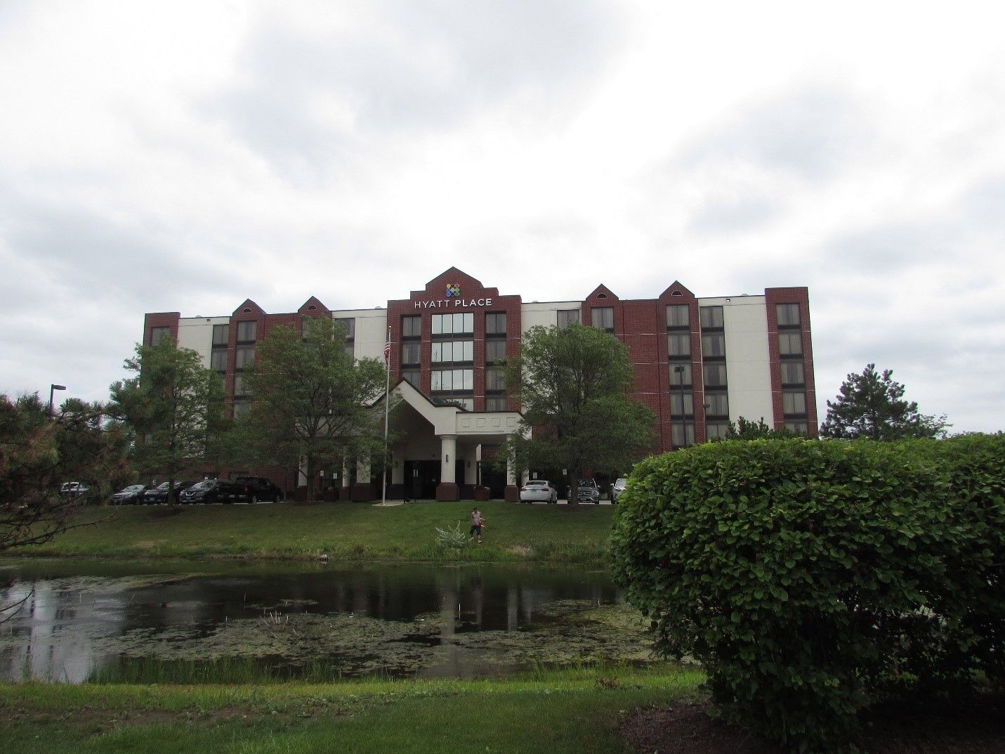 A large building with a pond in front of it