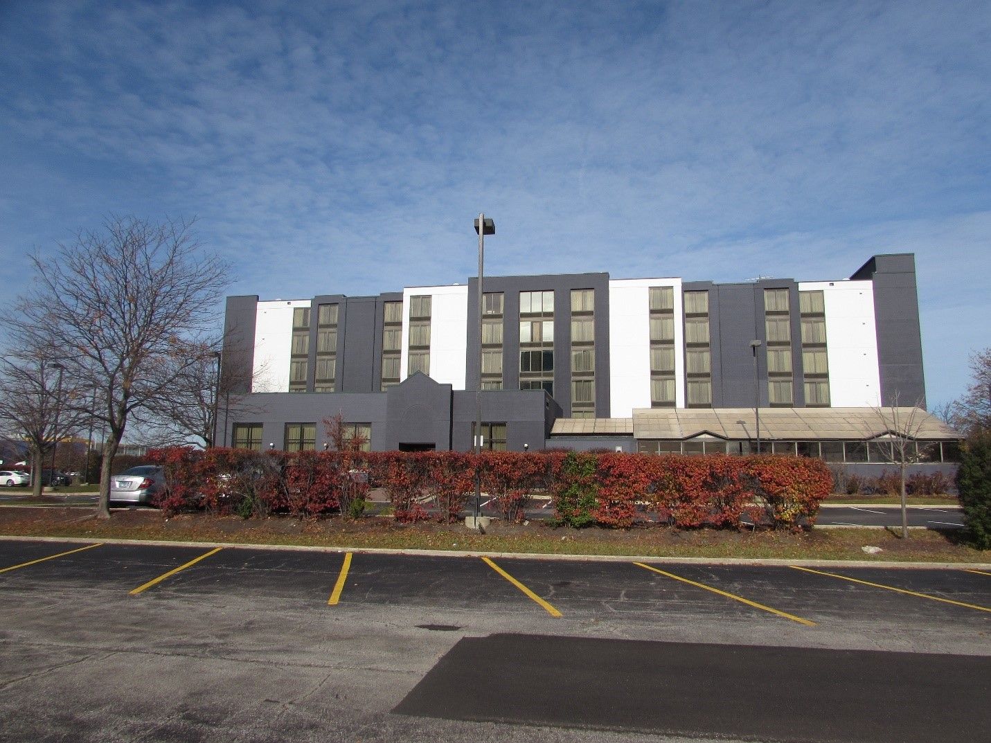A large building with a parking lot in front of it