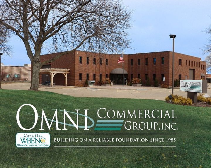 A large brick building with a sign that says omni commercial group inc.