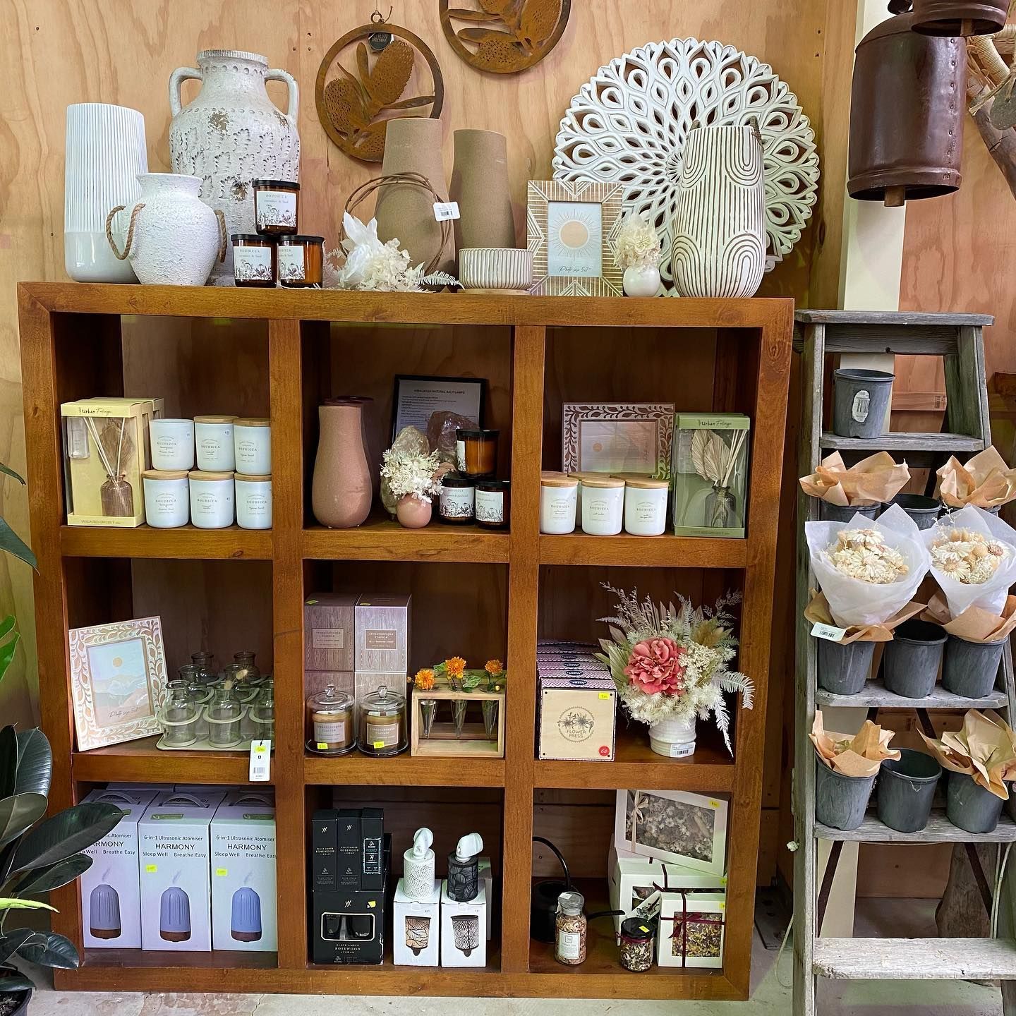 A Wooden Shelf Filled With Vases And Candles — Schutz Landscape and Garden Supplies in Tomerong, NSW