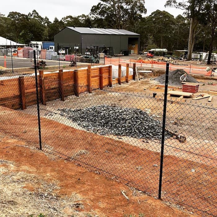 A Chain Link Fence Is Surrounding A Construction Site — Schutz Landscape and Garden Supplies in Tomerong, NSW