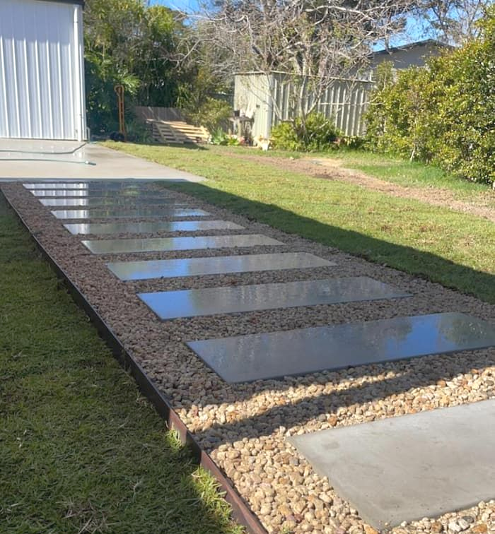 A Driveway With A Row Of Sandstone Steps Leading To A Garage — Schutz Landscape and Garden Supplies in Kangaroo Valley, NSW