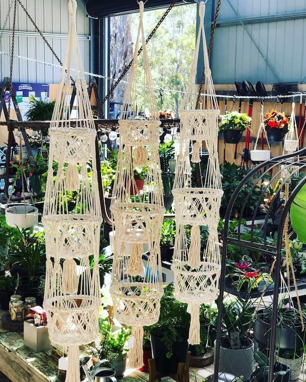 A Bunch Of Macrame Hanging Baskets Are Hanging In A Garden Center — Schutz Landscape and Garden Supplies in Tomerong, NSW