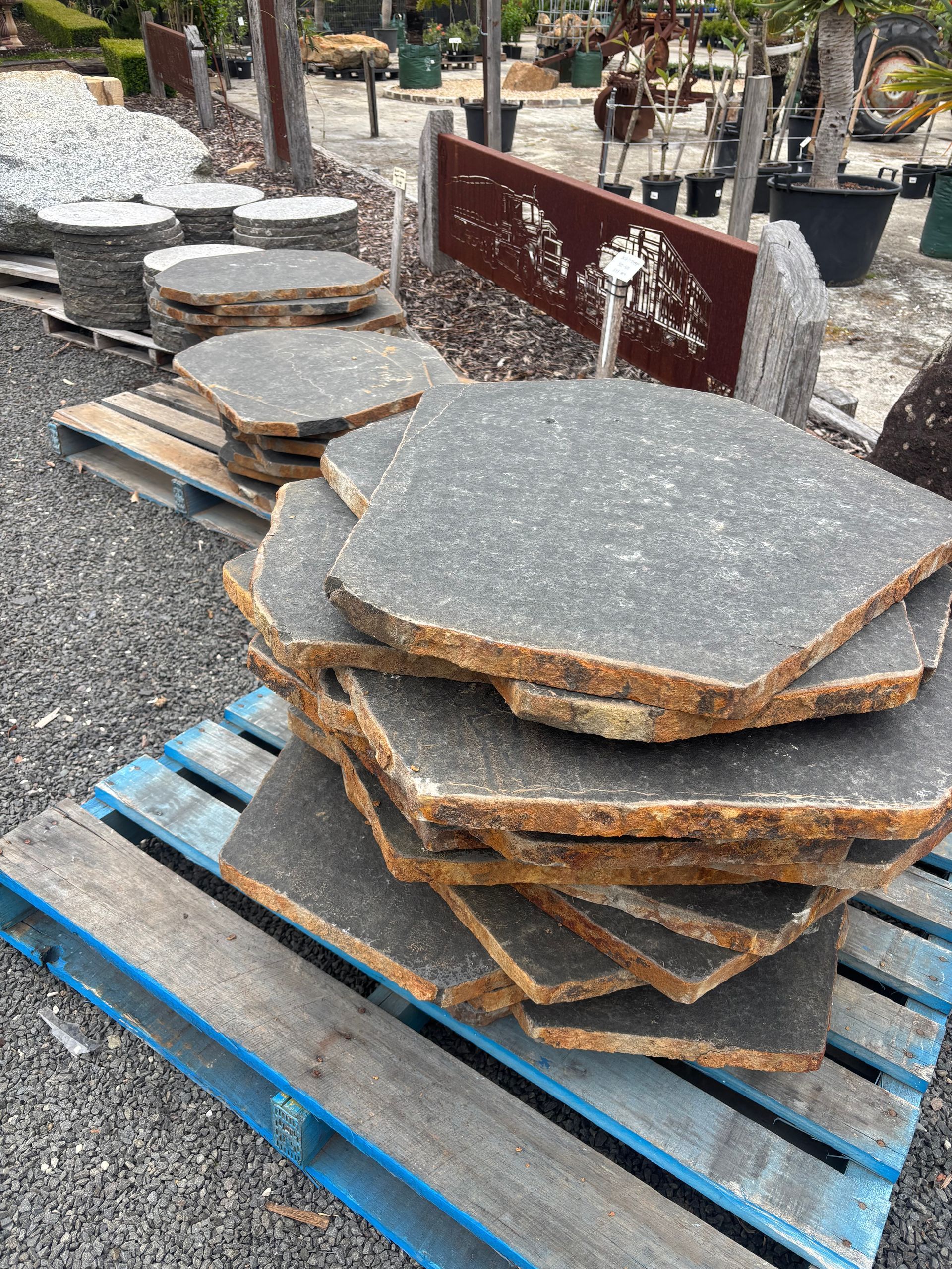 A stack of irregularly shaped, dark gray flagstones — Schutz Landscape and Garden Supplies in Tomerong, NSW