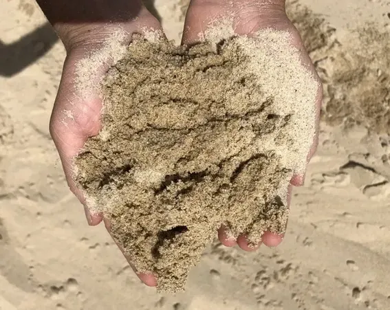 Two Hands Holding Sand — Schutz Landscape and Garden Supplies in Tomerong, NSW