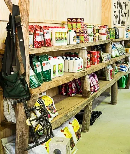 A Wooden Shelf Filled With Lots Of Bottles And Bags Of Food — Schutz Landscape and Garden Supplies in Tomerong, NSW