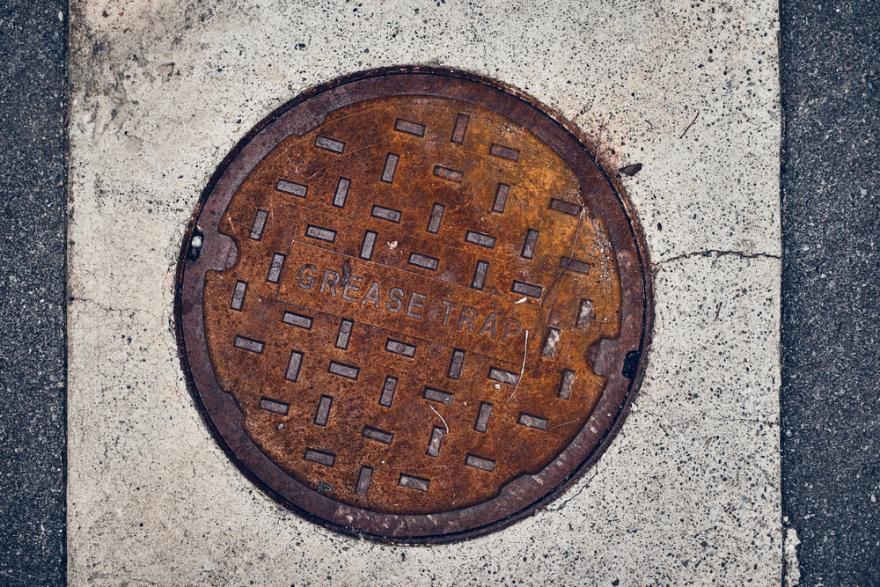 A Rusty Manhole Cover Is Sitting On The Ground — Gympie Septic Pump Outs In Banks Pocket, QLD