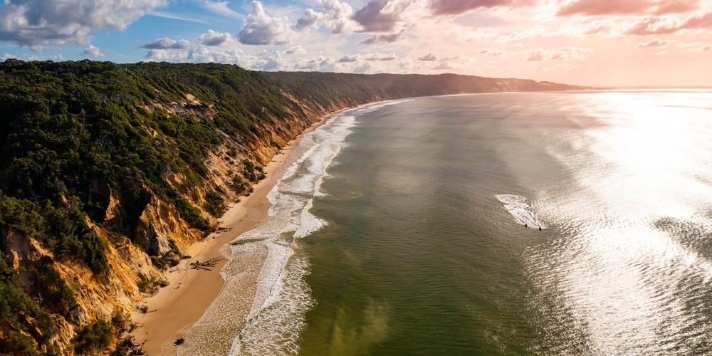 An Aerial View Of A Beach With A Cliff In The Background — Gympie Septic Pump Outs In Rainbow Beach, QLD