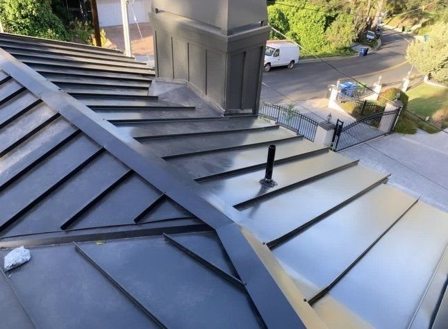 Blue corrugated metal roof with visible screws. Blue corrugated metal roof with visible screws.