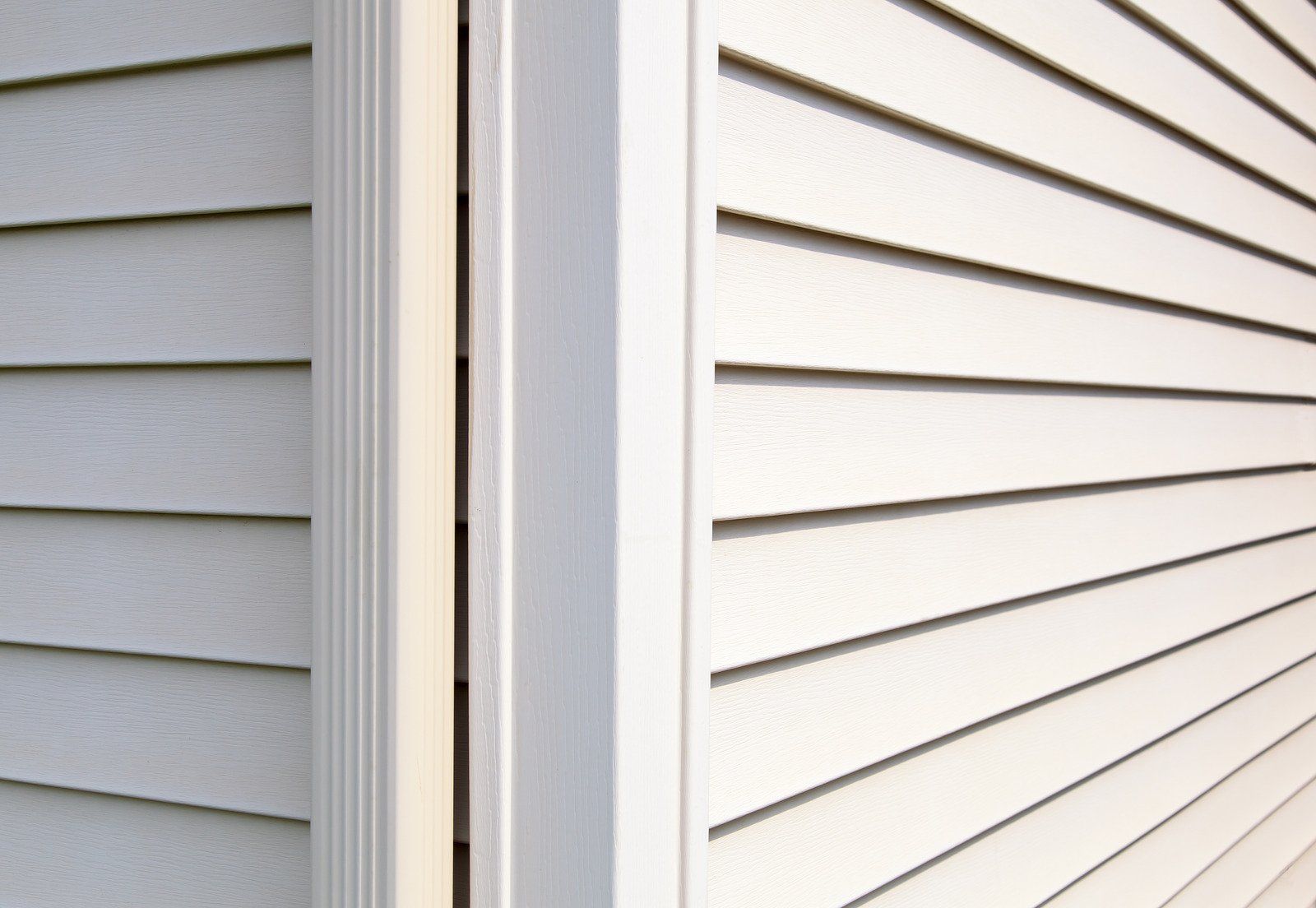 White siding and trim on a building's corner.