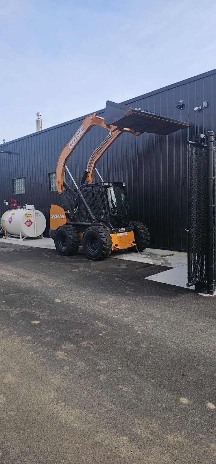 A bulldozer is parked in front of a building.