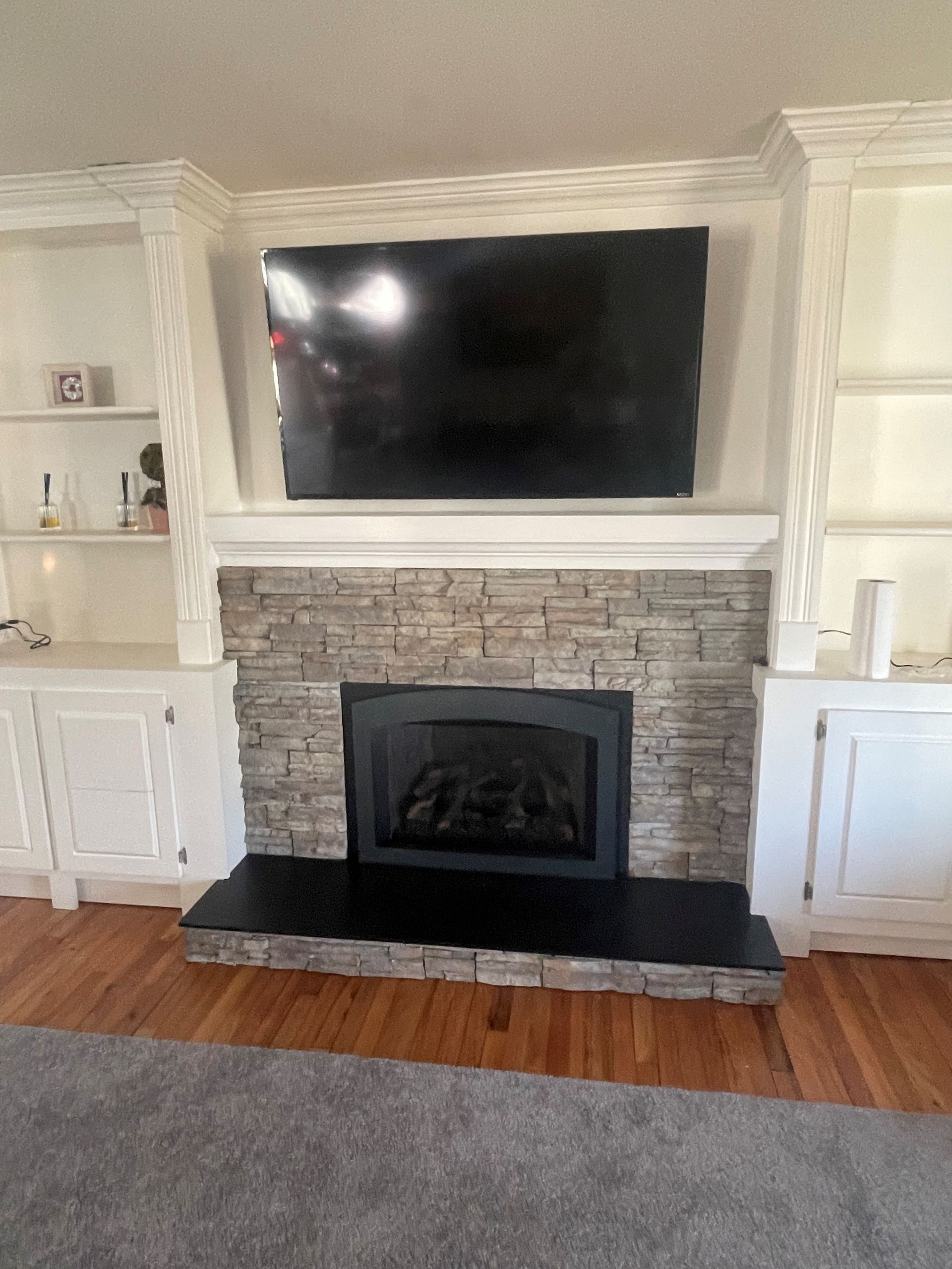 A fireplace with a flat-screen TV above it.