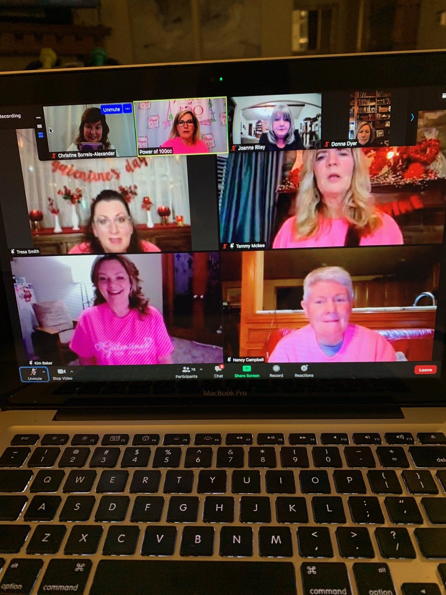 A group of women are having a video call on a laptop.