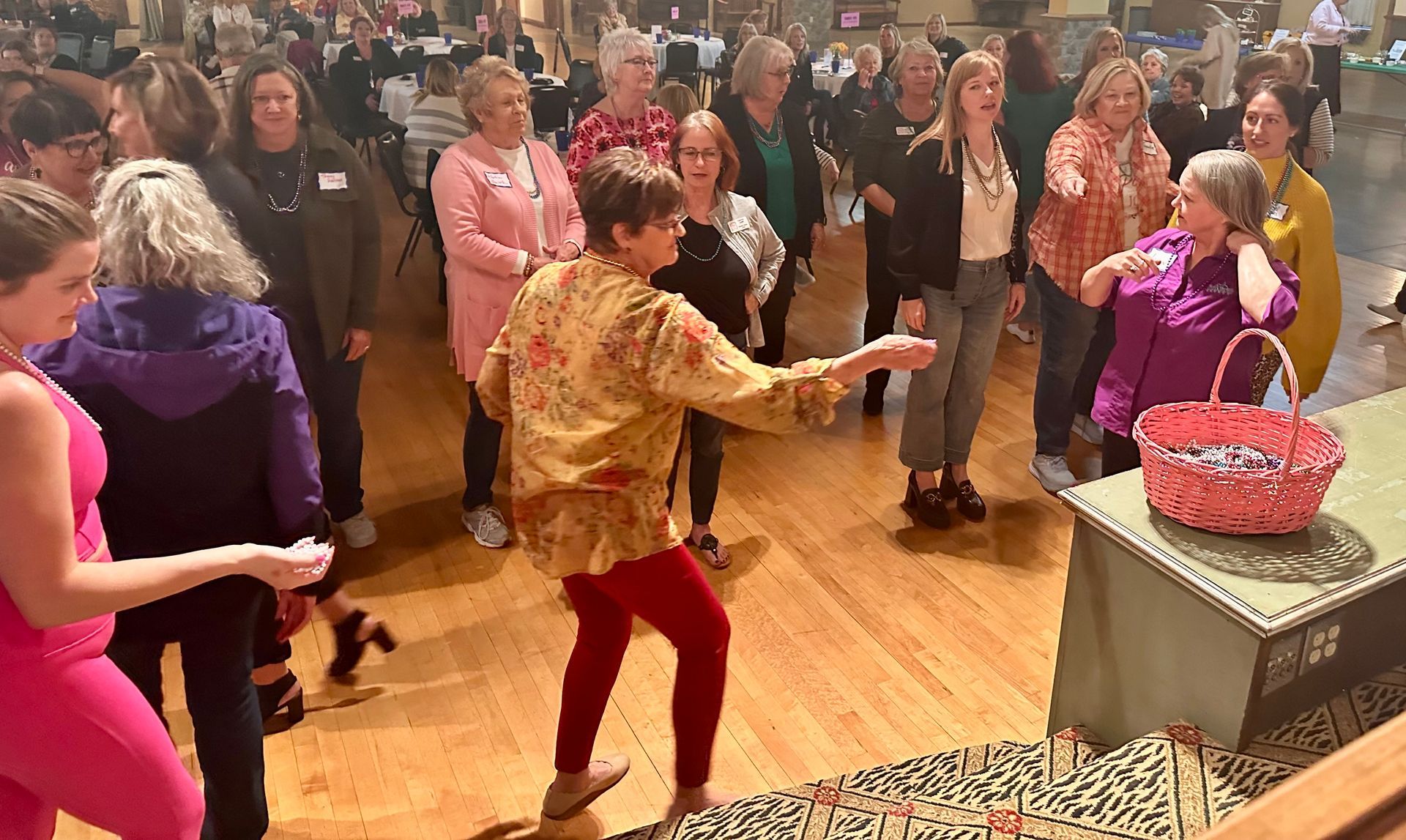 A group of women are dancing in a room.